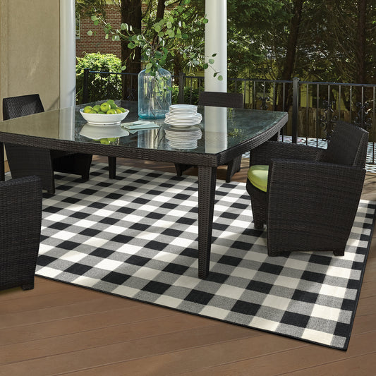 Polypropylene outdoor rug on a patio with vibrant colors and a cozy area rug indoors.